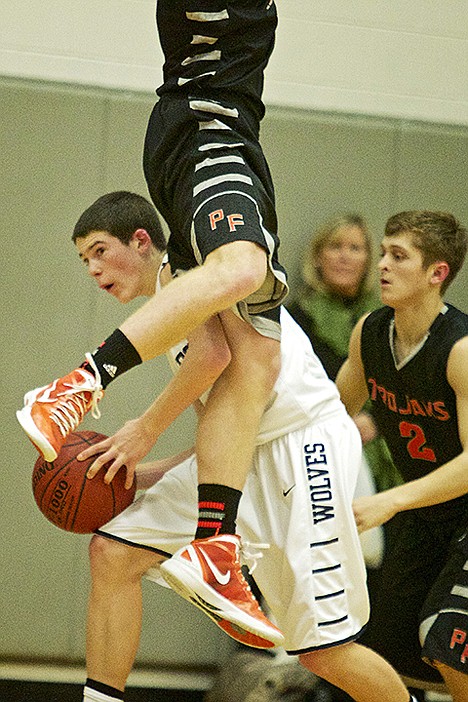 &lt;p&gt;Chuckie Adams from Lake City High looks for an outlet to pass to as a Post Falls High players falls on him during the second half.&lt;/p&gt;