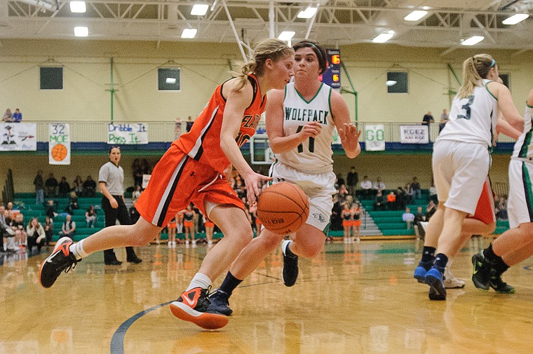 &lt;p&gt;Flathead senior Emma Andrews drives past Glacier junior guard Taylor Loomis (11) Thursday night during the crosstown basketball matchup at Glacier High School. Jan. 30, 2014 in Kalispell, Montana. (Patrick Cote/Daily Inter Lake)&lt;/p&gt;