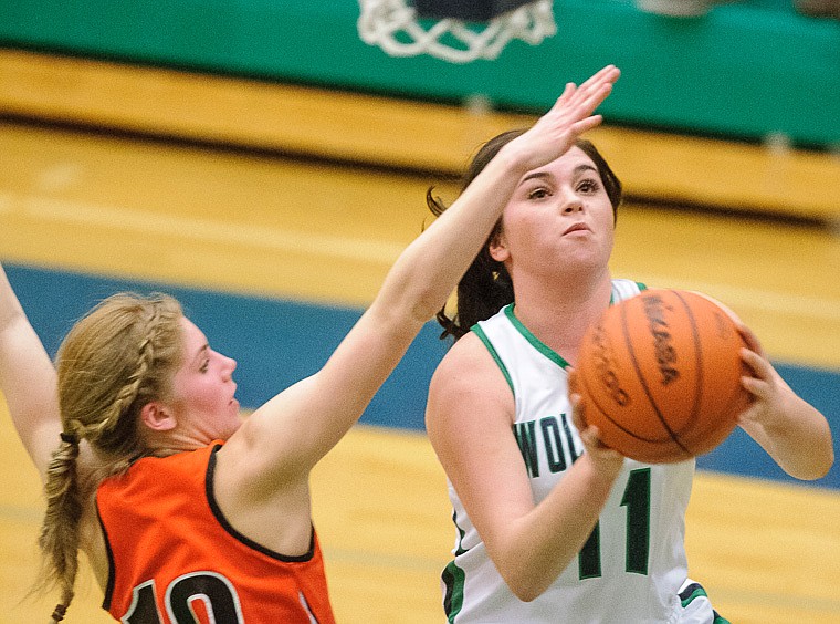 &lt;p&gt;Glacier junior guard Taylor Loomis (11) puts up a shot past Flathead senior Emma Andrews (10) Thursday night during the second half of Glacier's crosstown victory over Flathead at Glacier High School. Jan. 30, 2014 in Kalispell, Montana. (Patrick Cote/Daily Inter Lake)&lt;/p&gt;