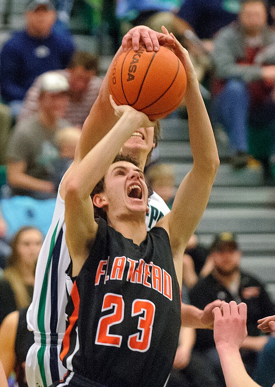 &lt;p&gt;Glacier senior post Kevin Malloy (35) blocks the shot of Flathead senior Chandler Escalante (23) Thursday night during the second half of Glacier's crosstown victory over Flathead at Glacier High School. Jan. 30, 2014 in Kalispell, Montana. (Patrick Cote/Daily Inter Lake)&lt;/p&gt;