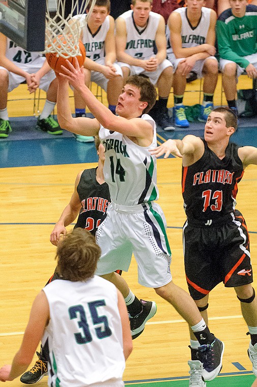 &lt;p&gt;Glacier senior guard Tanner Olsen (14) puts up a shot Thursday night during the second half of Glacier's crosstown victory over Flathead at Glacier High School. Jan. 30, 2014 in Kalispell, Montana. (Patrick Cote/Daily Inter Lake)&lt;/p&gt;