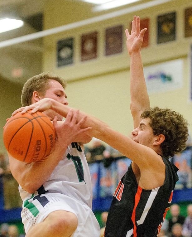 &lt;p&gt;Flathead senior Chandler Escalante (23) blocks the shot of Glacier senior guard Evan Epperly (10) Thursday night during the first half of the crosstown matchup between Glacier and Flathead at Glacier High School. Jan. 30, 2014 in Kalispell, Montana. (Patrick Cote/Daily Inter Lake)&lt;/p&gt;