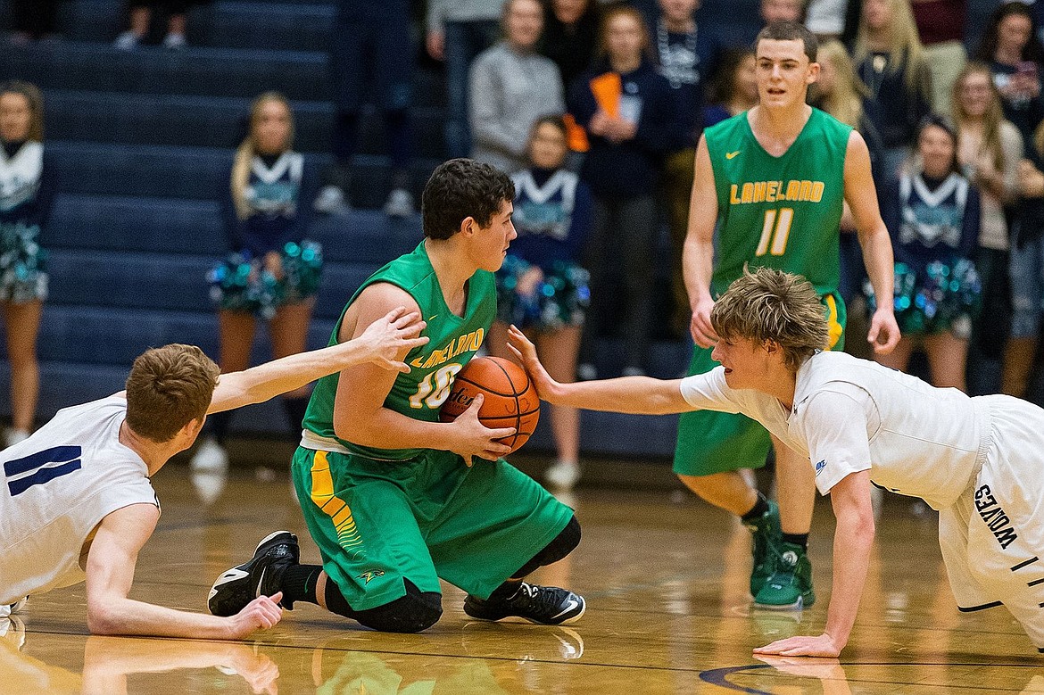 &lt;p&gt;SHAWN GUST/Press Lakeland&#146;s Jared McDaniel takes possession of a loose ball as Lake City defenders Duncan Butler (11) and Kyle Manzardo reach out to block passing options during the second quarter.&lt;/p&gt;