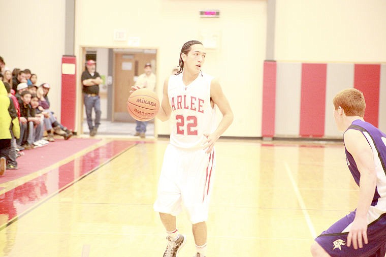 <p>Warriors guard Zack Camel surveys the floor in Arlee.  Camel set a state record by recording a staggering 23 assists in Arlee's win over St. Regis. </p>