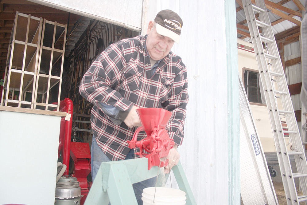 &lt;p&gt;Earl Eisenbacher grinds flour using one of the restored machines at his workshop near St. Regis.&lt;/p&gt;