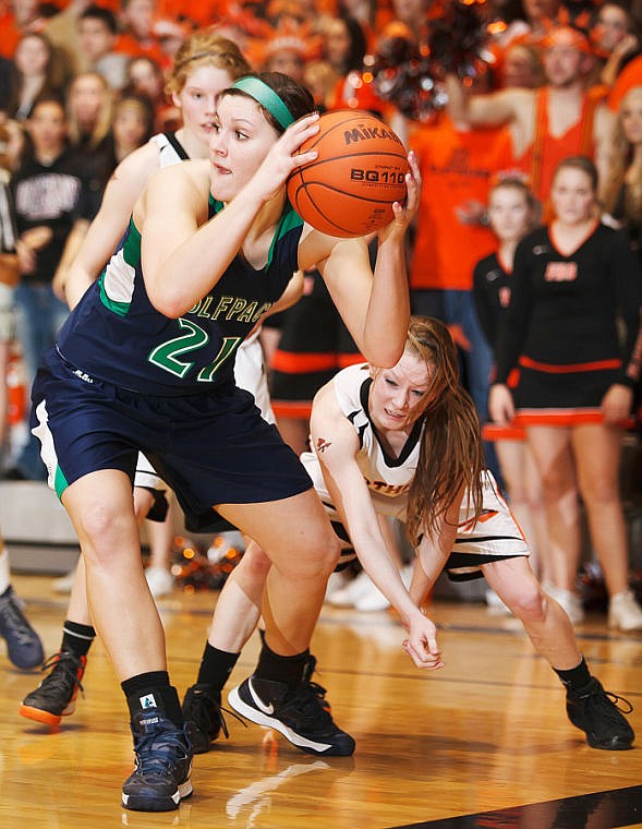 &lt;p&gt;Glacier junior Cassi Hashley (21) grabs a loose ball Tuesday night during the crosstown matchup at Flathead High School.&lt;/p&gt;