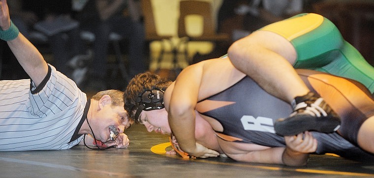 Whitefish freshman Wolf Zinke gets close to a pin during his match with Ronan junior Aaron Yazzi-Whitworth on Tuesday at Whitefish. Zinke went on to win by decision.