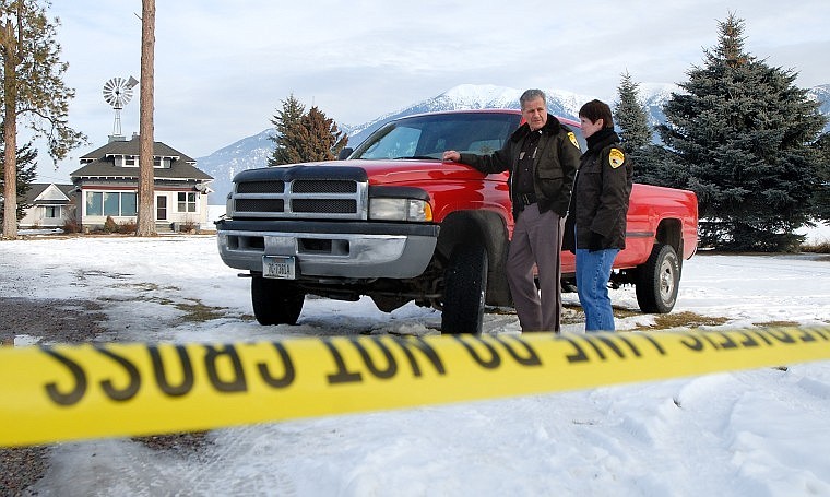 Flathead County Sheriff&#146;s Posse members Loyal and Sharon Chubb stand outside 521 Mennonite Church Road Friday morning. The bodies of murder victims Donald Roy Calbick, 60, and Stacey Michael Calbick, 38, were found in the home Thursday afternoon.