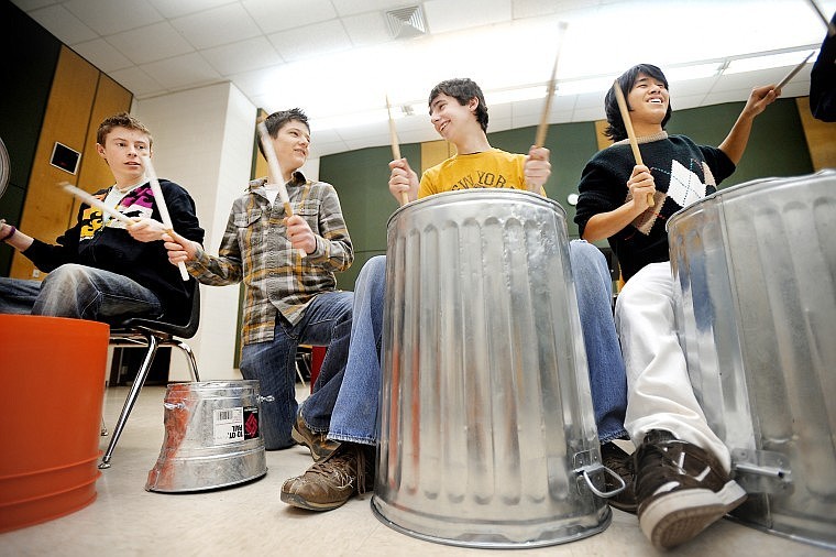 Nathan Knox, a junior, left to right, Keaton Morrison, a junior, Micah Groschupf, a sophomore and Nipitpon Buddhakosa, a senior, and other members of the Whitefish High School Drumline practice playing on buckets and cans for an upcoming performance on Feb. 20. According to Mark McCrady, the drumline is preparing a special halftime show which will feature the tunes &quot;Recycled&quot; and &quot;Talking Trash.&quot;