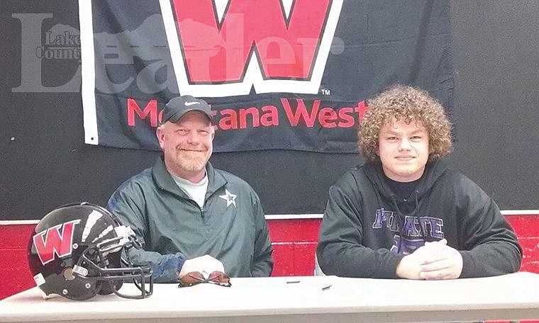 <p>Wyatt Jenson (right) signs his letter of intent to play football at the University of Montana-Western as Bulldogs coach B.J. Robertson looks on.</p>