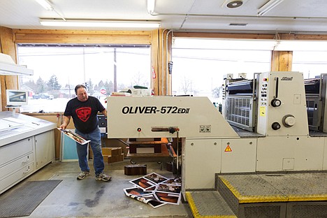 &lt;p&gt;Large windows allow daylight in on pressman Eugene Cranmer as he monitors a printing job.&lt;/p&gt;