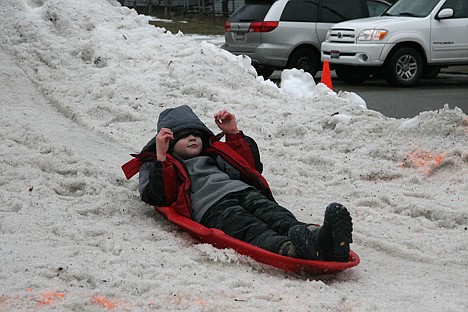 &lt;p&gt;Eight-year-old Ian Gardom slides down a snow mountain on Saturday at the Winter Fun Fest in Spirit Lake. Organizers built a giant hill in the middle of Maine Street.&lt;/p&gt;