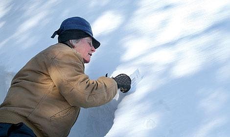Photo by Nick Ianniello<br>Carole Johnson of the Superior Ranger District measures the slope of a hill to determine the likelihood of an avalanche. Hills with a slope of 35 to 45 degrees are more likely to break loose, she said. Forest Service staff members regularly check snow conditions.