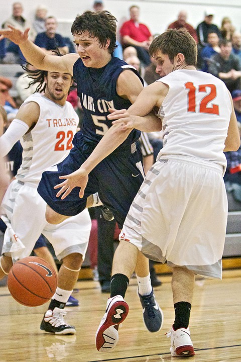 <p>JEROME A. POLLOS/Press Lake City High's Justin Pratt loses control of the ball while driving to the hoop against Taylor Valente from Post Falls.</p>