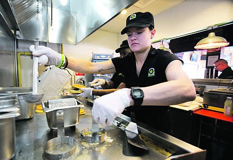 &lt;p&gt;BurgerFi restaurant employee Elia Carranza prepares to fry eggs for an order at the Aventura, Fla., restaurant on Tuesday. The company plans to nearly double in size from their existing 65 restaurants this year.&#160;&lt;/p&gt;