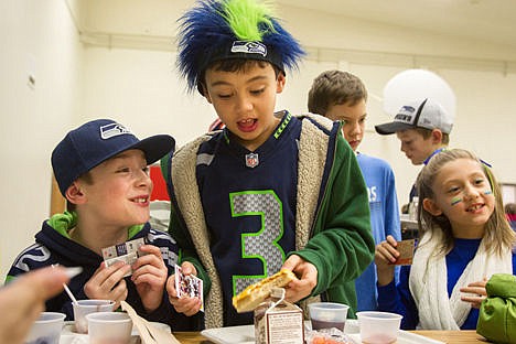 &lt;p&gt;Bryan Elementary 4th graders Cooper Erickson, left, Kyle Seman and Olivia Jolley trade football cards with fellow students on Friday during the school's sports themed lunch. Students that participated in hot lunch were given a football card from the school.&lt;/p&gt;