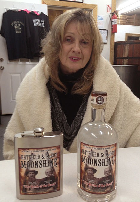 <p>Nancy Hatfield, great-great-granddaughter of Hatfield patriarch William Anderson "Devil Anse" Hatfield, is shown displaying products at the Hatfield &amp; McCoy Moonshine distillery on Jan. 22 in Gilbert, W.Va. </p>