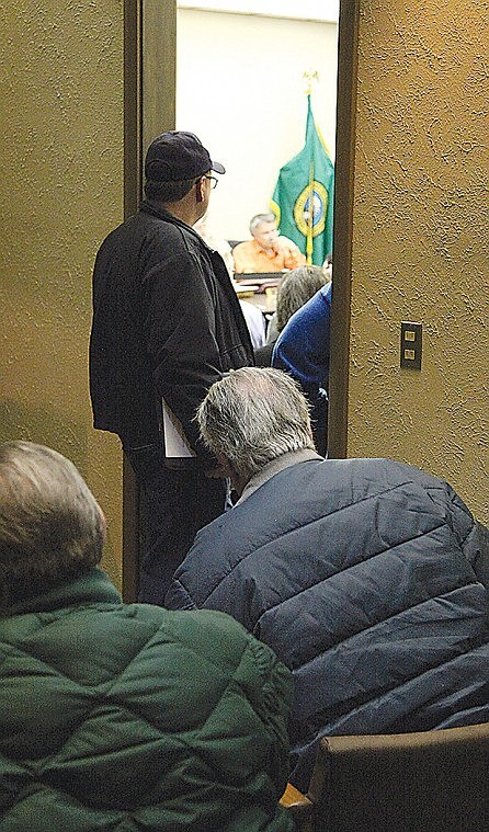 The Moses Lake Irrigation and Rehabiliation District meeting on
Jan. 24 was overflowing with audience members watching Rich Archer
and the board discuss issues.