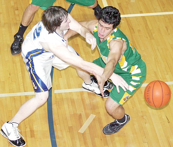 Libby's Garrett Craig passes the ball past Whitefish's Jose Sanchez on Saturday.