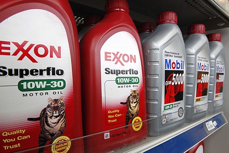 &lt;p&gt;In this photo, Exxon and Mobil oil products are displayed on a shelf in an Exxon mini-market in Carnegie, Pa. Exxon said Monday that net income grew 53 percent in the fourth quarter as oil prices rose and the company increased production.&lt;/p&gt;