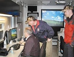 Chery Sabol/Daily Inter Lake&lt;br&gt;AERIAL SHOTS OF KEY LOCAL LANDMARKS are saved in the computer of a new disaster command center in Flathead County. Alan Marble, left, Randy Feller, and Chris Roberts fine-tuned the center Saturday. It's a portable communications center that will keep the Flathead in touch with the rest of the world and help process local information in the case of earthquakes or other calamity.