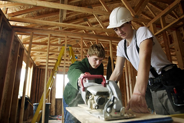 &lt;p&gt;JEROME A. POLLOS/Press Kade Green, 17, a student at Post Fall High School, cuts a section of board with a circular saw Tuesday as Isaac Regan, 16, from Lake City High holds the board at the Habitat for Humanity construction site in Coeur d'Alene. Students from the Riverbend Construction program have been assisting in the project since the foundation for the two homes were constructed in October.&lt;/p&gt;