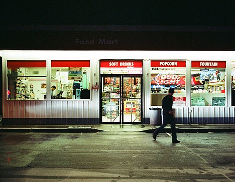 &lt;p&gt;A figure walks in front of an Exxon food mart on the corner of 15th and Sherman.&lt;/p&gt;