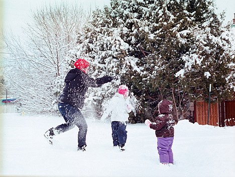 &lt;p&gt;On the corner of 12th Street and Front Avenue, Jodi Caldwell dumps snow on her granddaughter Annabelle Goodin, 5, as Maddison Goodin, 18 months, looks on during an impromptu snow fight.&lt;/p&gt;