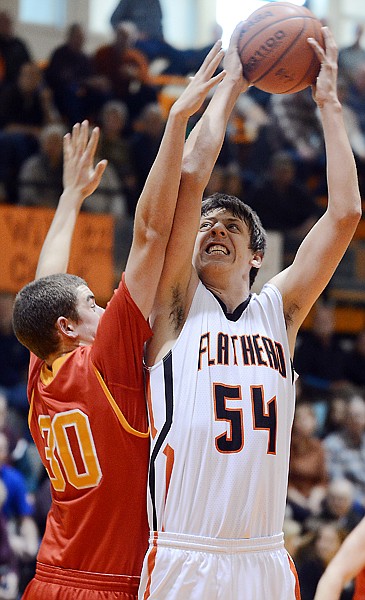 &lt;p&gt;Flathead senior Garth West (54) shoots over Missoula Hellgate junior Pat Colberg during Saturday&#146;s game at Flathead High School.&lt;/p&gt;