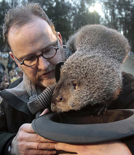 <p>AP Photo/Keith Srakocic/file Punxsutawney Phil, the weather predicting groundhog, crawls off the shoulder of handler Ben Hughes during the 2011 Groundhog Day festivities in Punxsutawney, Pa. The central Pennsylvania groundhog is set to make his annual weather prediction on Thursday just before 7:30 a.m. EST.</p>