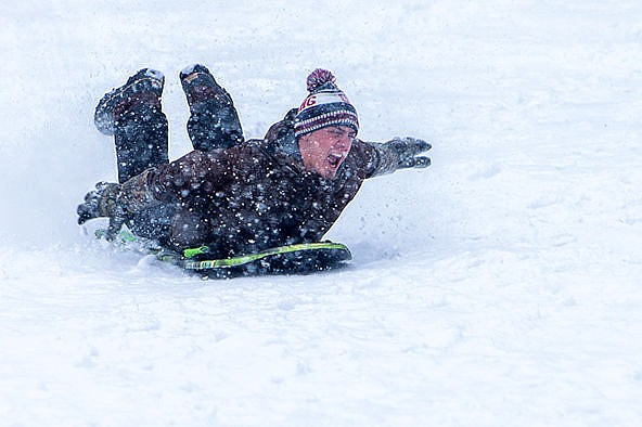 &lt;p&gt;Tristin Dunn, 19, sleds down the hill behind the Coeur d&#146;Alene Fire Station #3 during heavy snowfall on Friday afternoon.&#160;&lt;/p&gt;