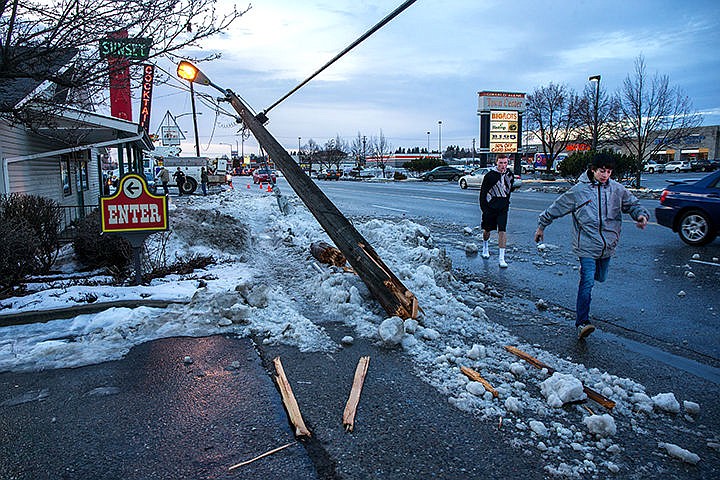 &lt;p&gt;Jaden Alicea, front, and Johnny Delbridge&#160;dodge a fallen utility pole on Appleway Drive on Tuesday afternoon. A driver of a Ford F-350 truck was traveling eastbound on Appleway Drive when their tire spun out causing them to hit the pole.&lt;/p&gt;