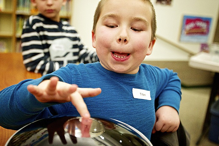 &lt;p&gt;JEROME A. POLLOS/Press Titan Russell, 6, attempts to touch a projection of a pig placed inside a parabolic mirror during a demonstration of optical illusions during an extreme science class Thursday after school at West Ridge Elementary in Post Falls.&#160;Radical Rick Turner has presented a series of &quot;extreme science&quot; demonstrations during the interactive hour-long show.&lt;/p&gt;