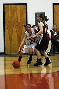 Diamond LaDeaux drives past a Trojan defender in the Trotters 57-38 win over Troy on Saturday. LaDeaux led all scorers with 19 points in the contest.