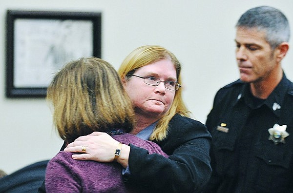 Flathead County Deputy Attorney Lori Adams puts her arm around Diana Johnson, Caden's Odell's grandmother, following Justine Winter's guilty verdict announcment at the Flathead County Courthouse on Thursday evening.