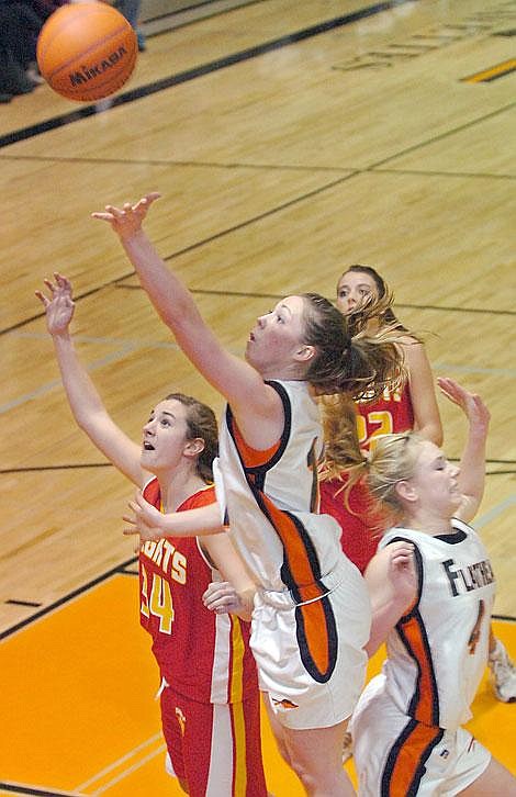 Flathead&#146;s Kendalyn Habel goes up for a shot while Missoula Hellgate&#146;s Katy Gannon defends during second-half play on Saturday. At right is Flathead&#146;s Kaylyn Heaton. Karen Nichols/Daily Inter Lake