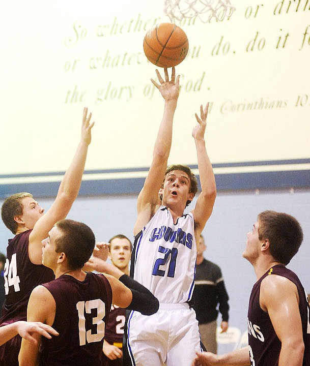 &lt;p&gt;Stillwater Christian's BJ Bach floats a shot in a crowd of Troy defenders at Stillwater on Tuesday. (Aaric Bryan/Daily Inter Lake)&lt;/p&gt;