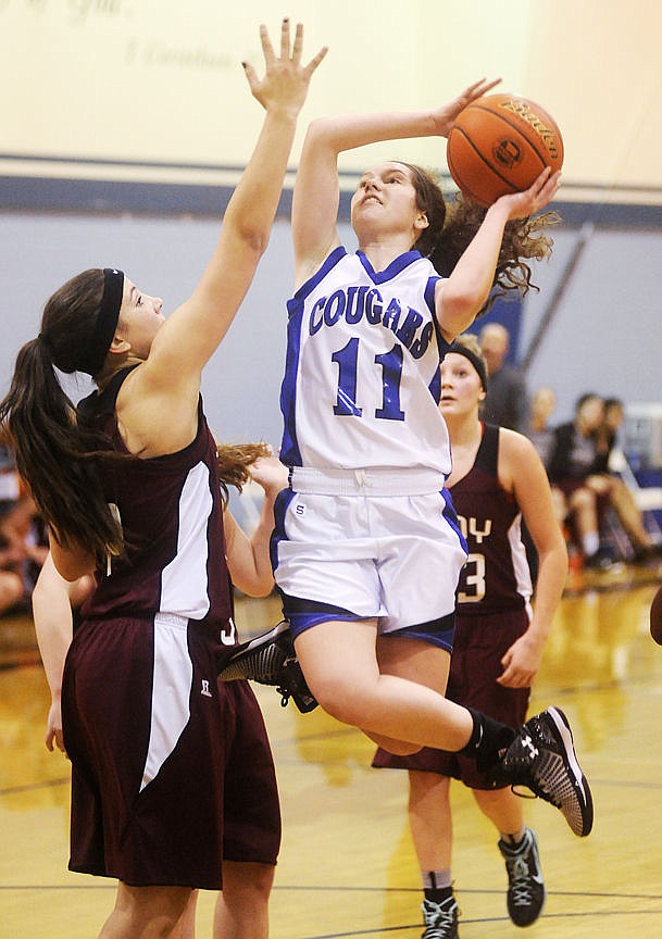 &lt;p&gt;Stillwater Christian's Serena Koch lofts a shot over Troy's Aurora Becquart during the Cougars 58-56 win at Stillwater on Tuesday. (Aaric Bryan/Daily Inter Lake)&lt;/p&gt;