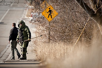 &lt;p&gt;A bomb disposal technician look for oncoming traffic before crossing Third Avenue in Post Falls where two suspected explosive devices were detonated Wednesday after being found by a city water department employee.&lt;/p&gt;