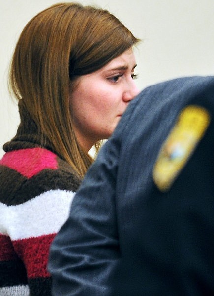 Justine Winter stands before being taken into custody.