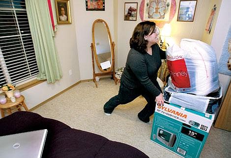 Melissa Lake of Evergreen pushes boxes out of her room at her parents&#146; house while packing her car before heading to Montana State University in Bozeman. Lake graduated from Flathead High School and Flathead Valley&lt;br&gt;Community College last year and started classes this month at MSU as a junior. She is pursuing a degree in ophthalmology and ultimately plans to work in&lt;br&gt;Third World countries. Craig Moore/Daily Inter Lake