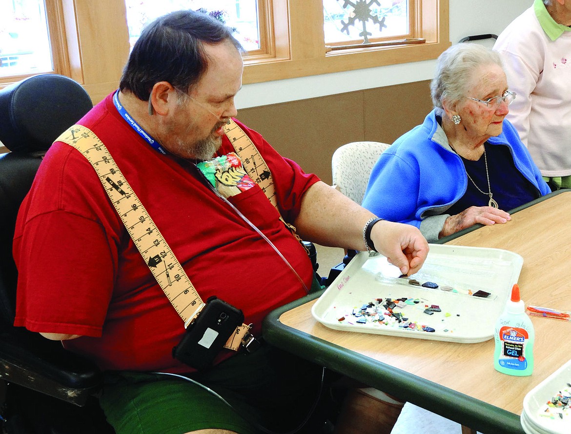 &lt;p&gt;Ray Taylor places mosaic pieces to glass to be fused into wind chimes. (Sue Cox/Stumptown Art Studio)&lt;/p&gt;