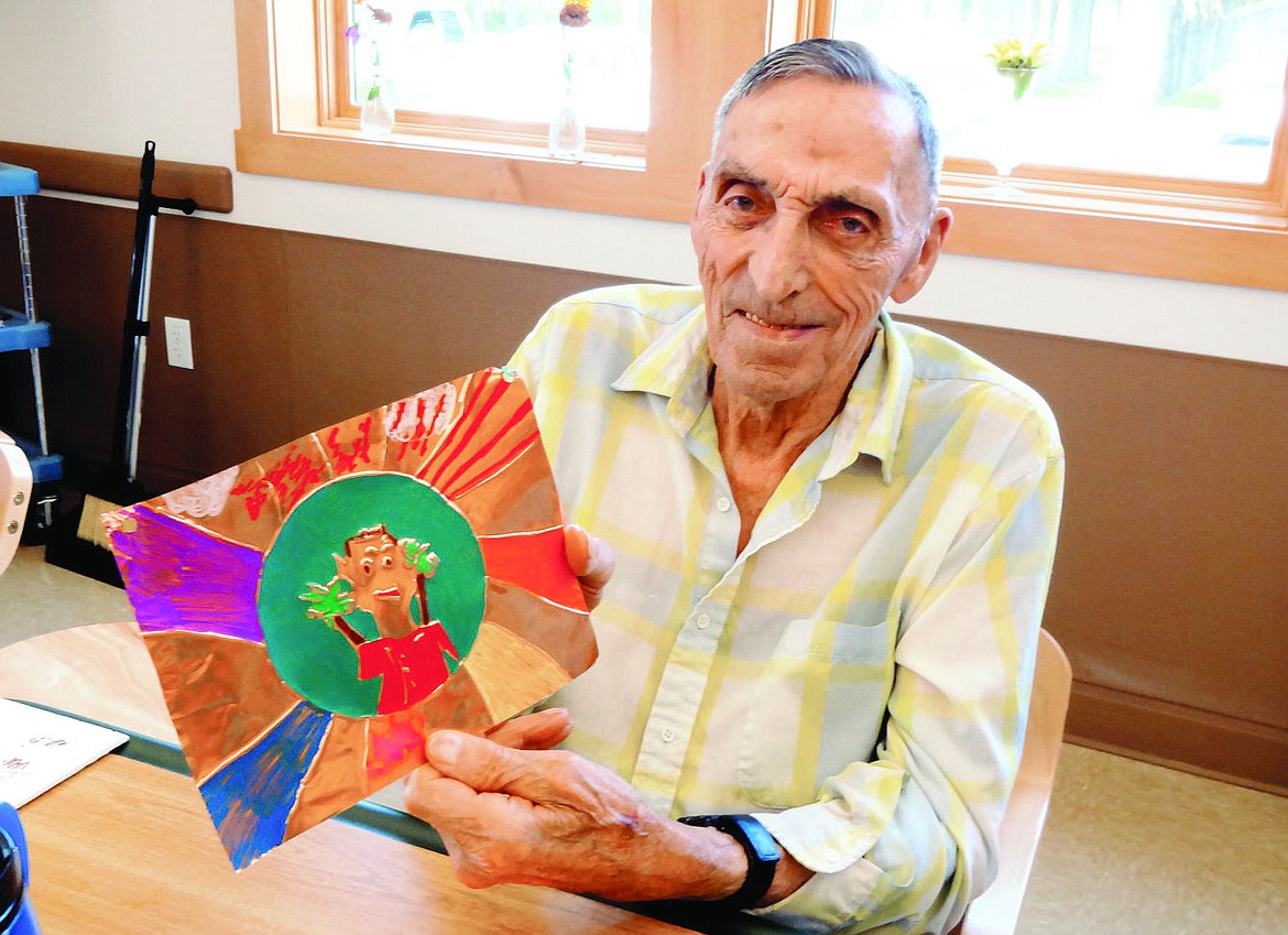 &lt;p&gt;Robert Rales shows off his embossed foil Aztec sun. Being nearly blind with macular degeneration has not slowed him down. He is able to feel the ridges of the embossed metal to know where to add color. (Sue Cox/Stumptown Art Studio)&lt;/p&gt;