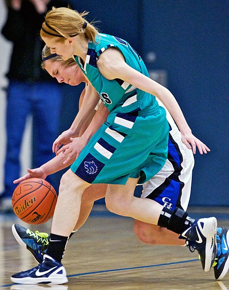 <p>Coeur d'Alene High's Madison Sumner, background, mimics Lake City High's Jansen Butler's movement while playing tight defense in the first half of the Viking's 58-35 win over the Timberwolves in the 5A Region 1 tournament Friday.</p>
