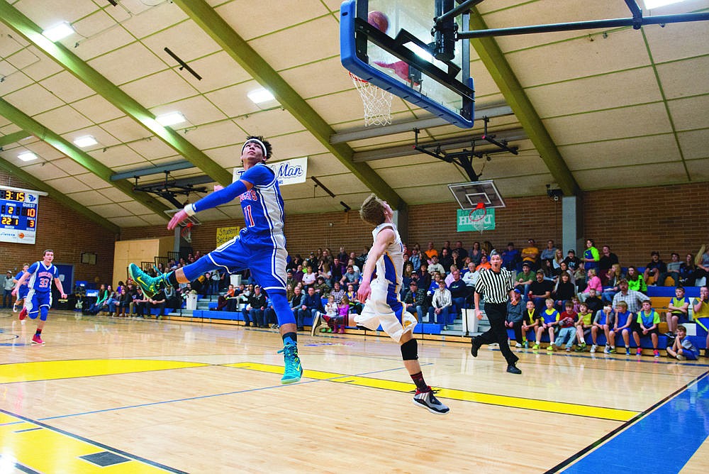 <p>Tanner Laws, of Thompson Falls, watches as the basketball goes through the hoop during Friday night's win against Superior.</p>
