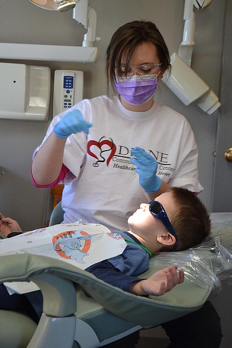 &lt;p&gt;Dylan Grubar, 5, lays back and enjoys the warm lights as volunteer dental hygienist Bethany Wise prepares the dental floss.&lt;/p&gt;