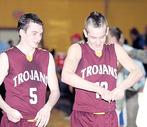 &lt;p&gt;Luke Haggerty, left, and Gage Tallmadge after defeating the Loggers 60-48 Friday night at Ralph Tate Gymnasium.&lt;/p&gt;