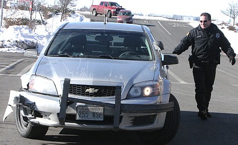 &lt;p&gt;WSP Sgt. Douglas Jacobs returns to his damaged vehicle.&lt;/p&gt;