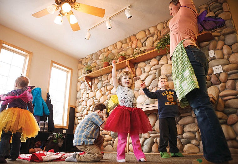 &lt;p&gt;Oliva Walter, center, stretchs her arms up as Sara Walburg-Owens, right, leads yoga exercises for a group of 2- and 3-year-olds Wednesday morning at Firefly Children's Center and Healing Arts in Kalispell.&#160;&lt;/p&gt;