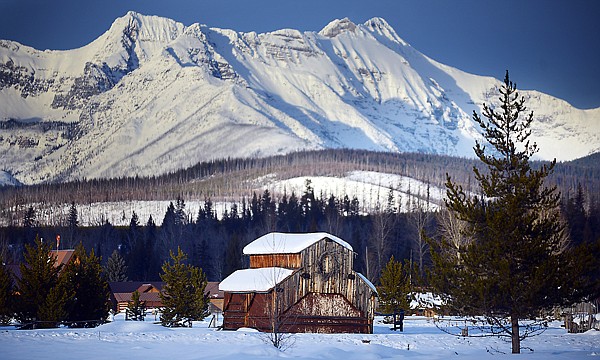 &lt;p&gt;Snow-capped peaks of Glacier National Park rise above a barn in the Polebridge area of the North Fork.&lt;/p&gt;